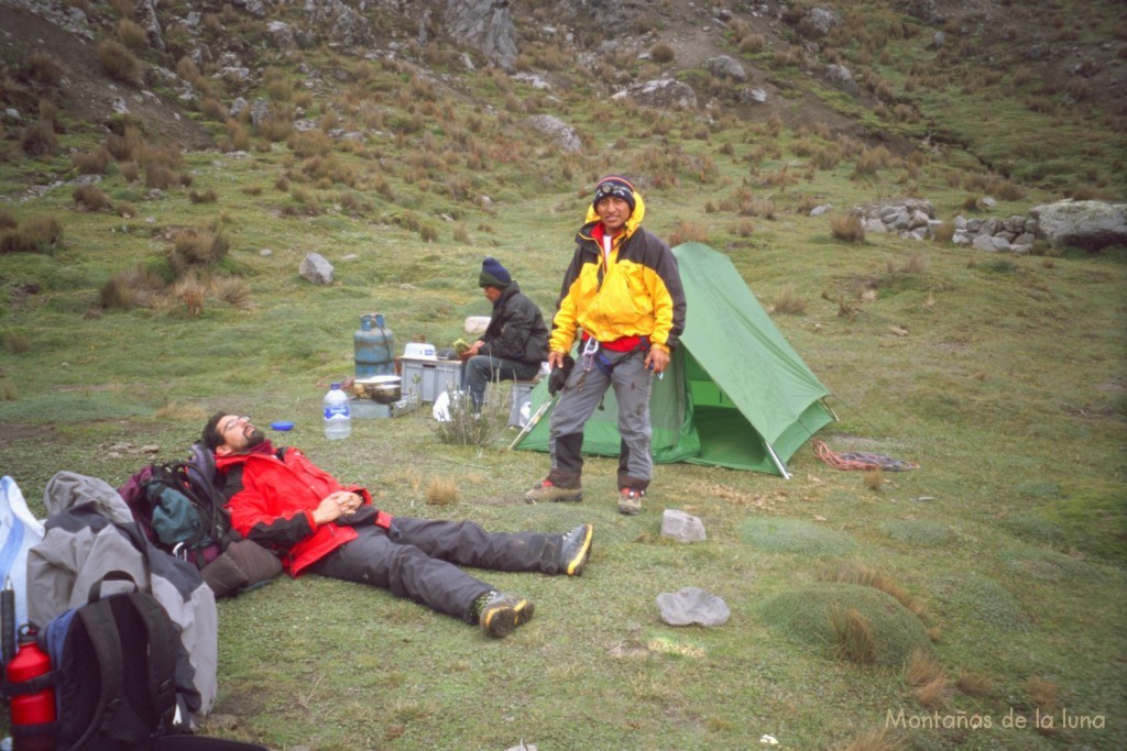 Jesús estirado en el suelo y Paco en el campo base del Carihuayrazo, 4.300 mts. aproximadamente, detrás sentado y preparando la comida, Segundo